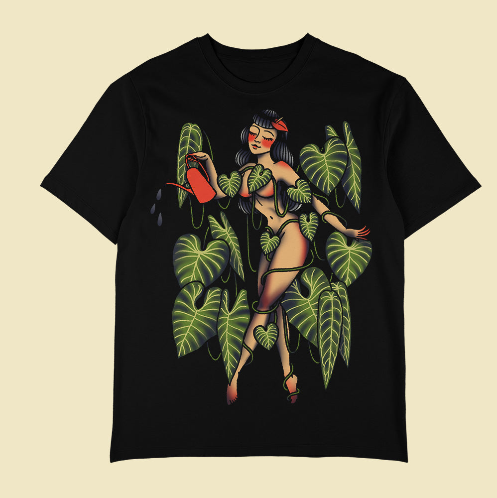 Black T-shirt with a tattoo-style woman holding a red watering can among green leaves and vines.