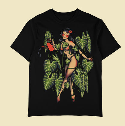 Black T-shirt with a tattoo-style woman holding a red watering can among green leaves and vines.